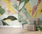 Abstract watercolor leaf wall mural with earthy green, yellow, and terracotta tones in a modern botanical design.