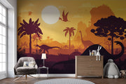 Kids’ dinosaur wall mural featuring silhouettes of Brachiosaurus, Pterosaurs, and prehistoric trees against an orange sunset, ideal for a playful bedroom or playroom.
