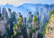 Zhangjiajie Mountain landscape wall mural featuring sandstone pillars, lush greenery, and misty peaks.