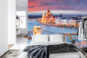 Budapest Skyline Wall Mural featuring the Hungarian Parliament, Chain Bridge, and the Danube River glowing under a vibrant sunset; decorating a bedroom.