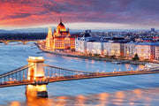 Budapest Skyline Wall Mural featuring the Hungarian Parliament, Chain Bridge, and the Danube River glowing under a vibrant sunset.