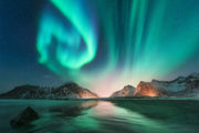 Northern lights wall mural featuring green and blue auroras over snowy mountains and a frozen lake, creating a mesmerizing and tranquil atmosphere.