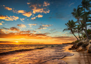 Golden sunset wall mural with palm trees, vibrant sky, and tranquil ocean waves, creating a relaxing and coastal living room ambiance.