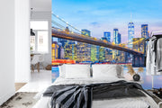 New York City Brooklyn Bridge wall mural featuring the Manhattan skyline at twilight in a modern bedroom with white decor.