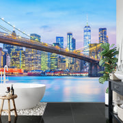 New York City Brooklyn Bridge wall mural featuring the Manhattan skyline at twilight in a modern bathroom.