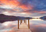 Wall mural of a sunset lake with a wooden dock extending into calm waters.