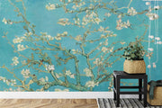 Wall mural of almond blossoms on a turquoise background, inspired by classic artwork, enhancing a modern living room with artistic elegance.
