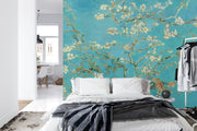 Wall mural of almond blossoms on a turquoise background, inspired by classic artwork, enhancing a modern bedroom with artistic elegance.