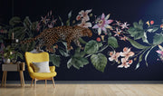 Exotic Leopard Wall Mural featuring a detailed leopard walking through lush tropical flowers and leaves on a dark background.
