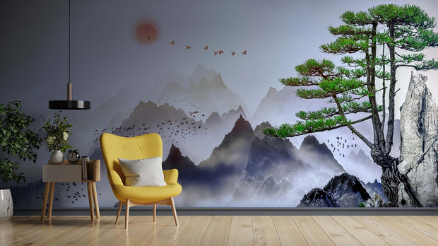 Minimalist Japanese mountain landscape wall mural with coral sunset and flying birds, styled in modern living room with yellow chair.