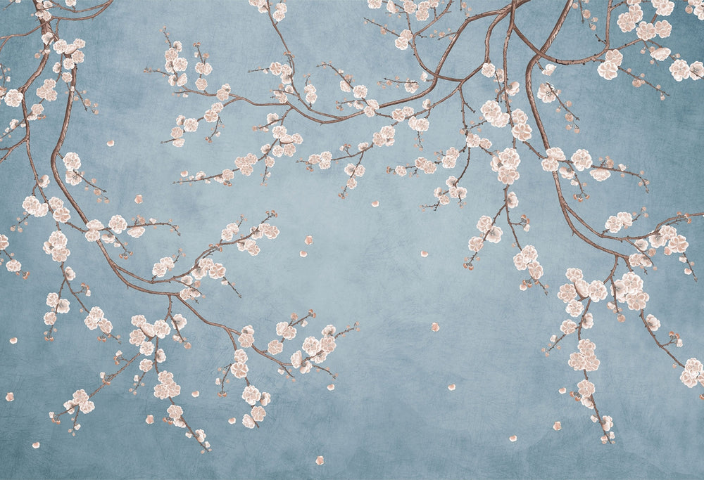 Cherry blossom wall mural with white flowers on twisting branches set against a rich blue background, creating a peaceful and stylish interior decor.