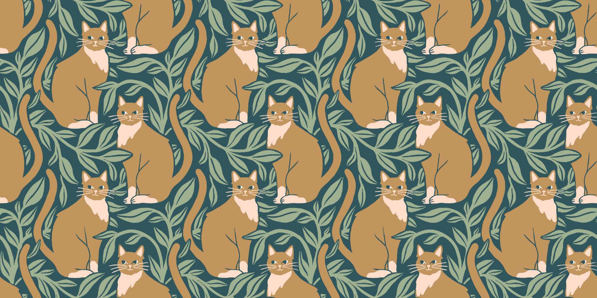 Whimsical wall mural featuring orange cats surrounded by green leaves.