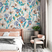 Modern artistic floral wall mural with bold blue, coral, and green flowers, styled in a bright bedroom.