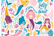 Colorful mermaid-themed wall mural in a children's playroom, featuring smiling cartoon mermaids with vibrant tails, sea creatures and coral.