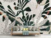 Lush foliage wall mural with bold green, beige, and rust botanical patterns and abstract dotted accents.