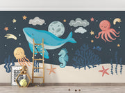 Ocean-themed kids' wall mural with a blue whale, octopus, starfish, and sea creatures in a playful underwater setting.