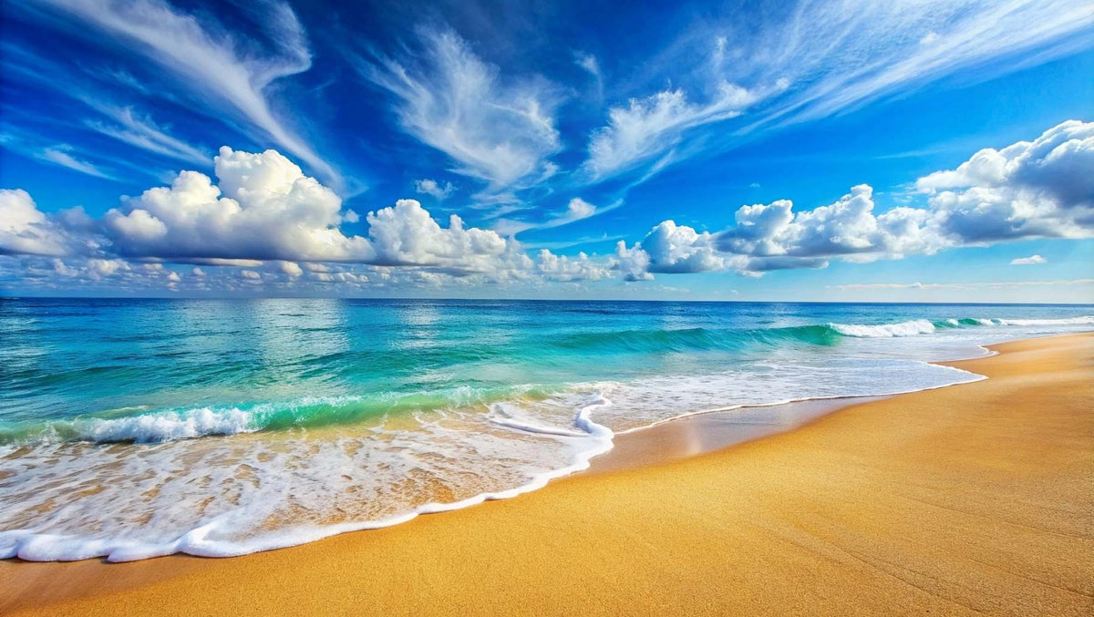 Serene beach wall mural featuring turquoise ocean waves, golden sand and a blue sky with fluffy clouds.