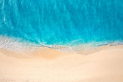 Crystal-clear ocean wave wall mural with turquoise waters and sandy shores.