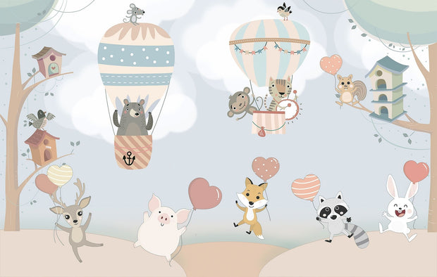 Nursery wall mural with pastel-colored forest animals flying in hot air balloons, surrounded by trees, clouds, and heart-shaped balloons