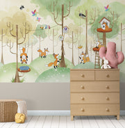Woodland fox wall mural featuring playful foxes, treehouses, and a lush green forest; perfect for nursery, kid's bedroom or playroom décor.
