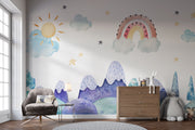 Watercolor kids' room mural with pastel mountains, a rainbow, a sun, clouds, and stars for a dreamy, playful atmosphere.