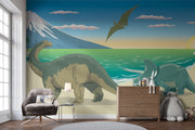 Dinosaur wall mural featuring a scenic beach with a Brachiosaurus, Triceratops, ocean waves, and a soaring Pteranodon at sunset.