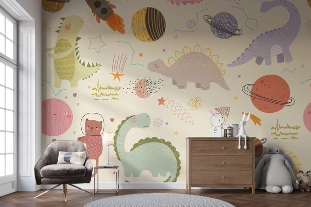 Children's room with Dino Galaxy Wall Mural featuring whimsical dinosaurs, rockets, planets, and stars in pastel colors, creating a magical space-themed decor.