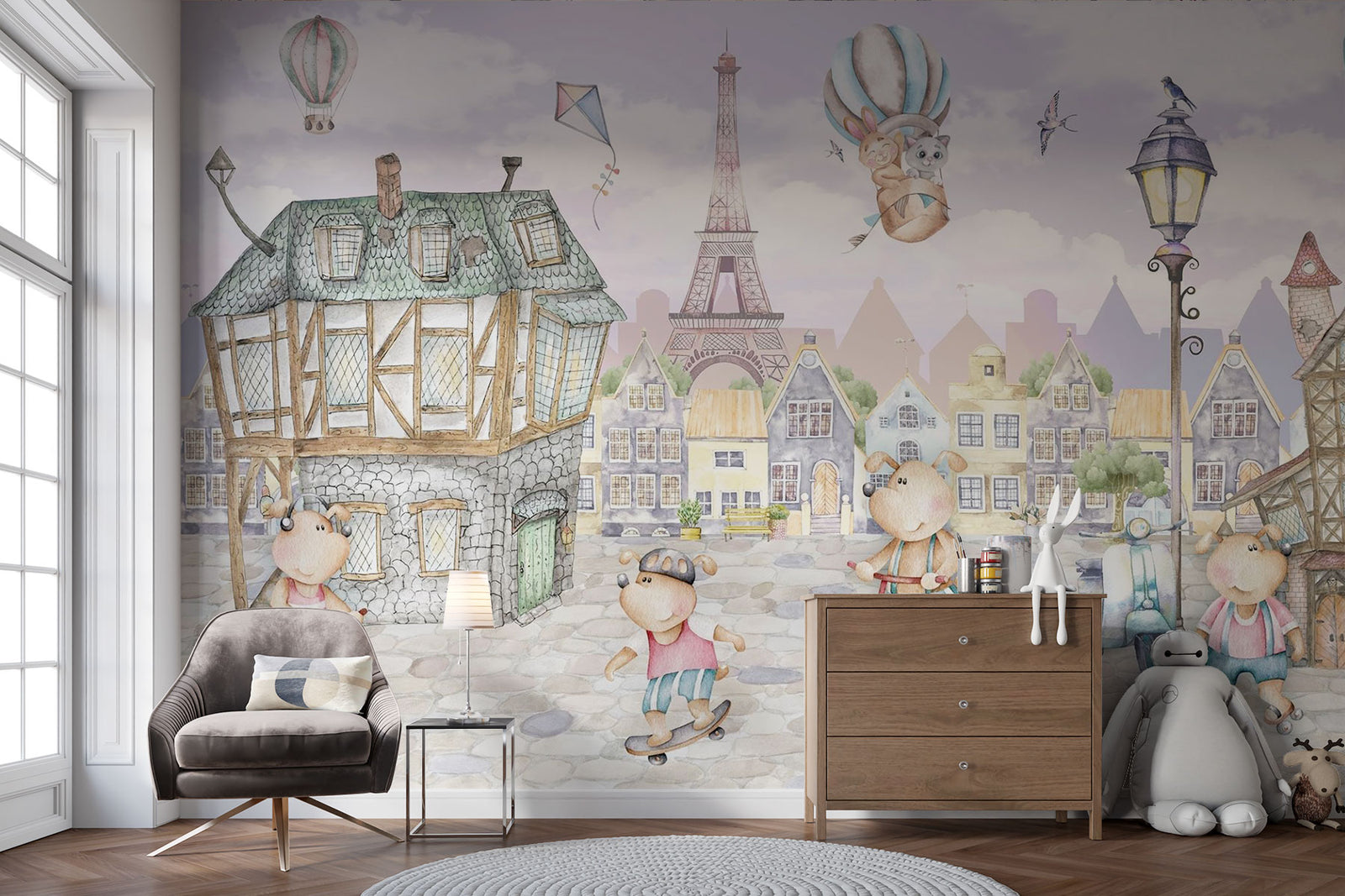 A whimsical Paris-inspired nursery wall mural featuring teddy bears on scooters and bikes, cobblestone streets, and the Eiffel Tower in pastel tones.