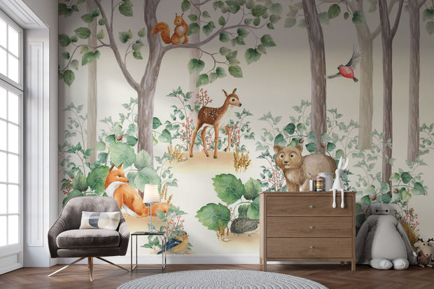 Woodland-themed wall mural featuring a bear cub, deer, squirrel, birds and lush green trees, decorating a cozy children's bedroom with a wooden house bed and natural decor.
