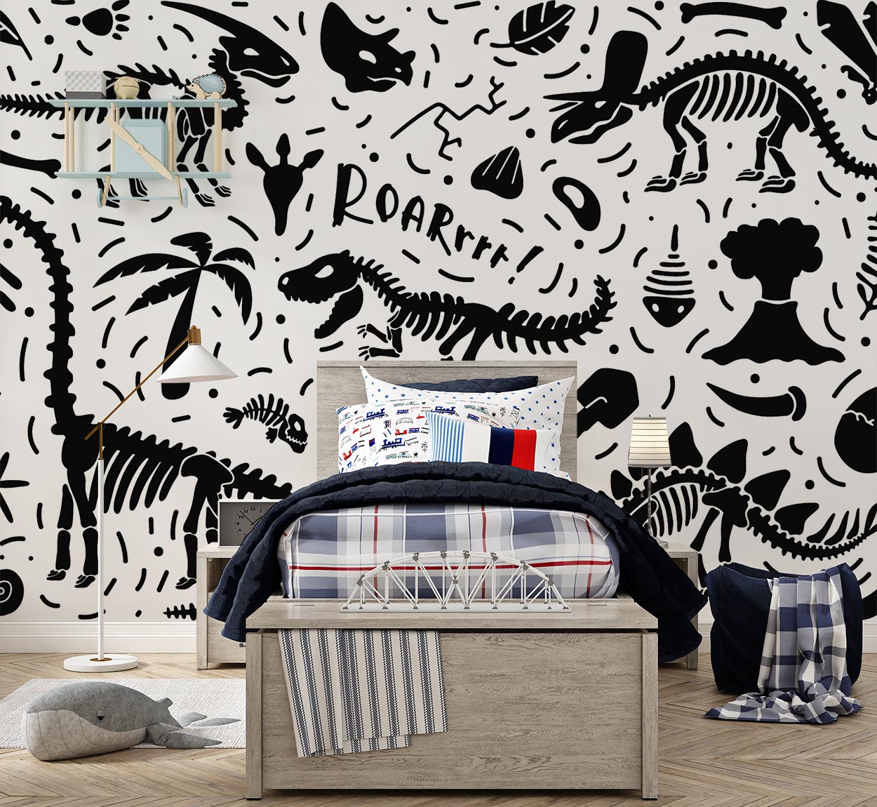 Black-and-white dinosaur-themed wall mural with skeletons, fossils, and "ROAR" text, decorating a kid's bedroom with a cosy bed, playful bedding and a modern lamp