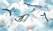 Underwater ocean wall mural with watercolor whales, jellyfish, and coral reefs in calming blue tones.