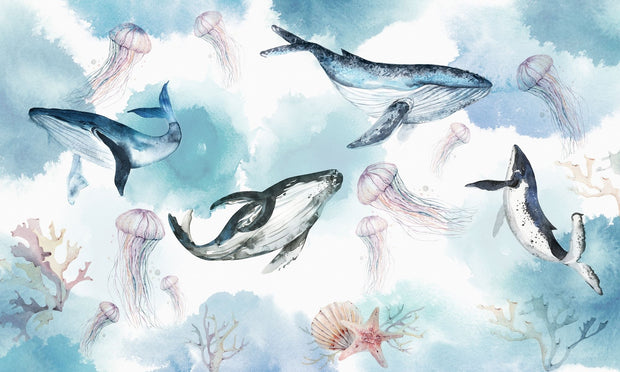 Underwater ocean wall mural with watercolor whales, jellyfish, and coral reefs in calming blue tones.