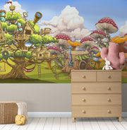 Fantasy wall mural featuring whimsical treehouses, oversized mushrooms, and fairy-tale cottages in a vibrant, enchanted forest setting for kids’ rooms.