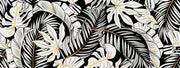 Black and white tropical leaf wall mural with gold accents, featuring monstera and palm leaves in a modern botanical design.