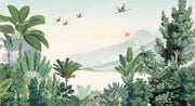 Scenic jungle wall mural with green tropical leaves, misty mountains, and flying cranes against a soft sunrise backdrop.