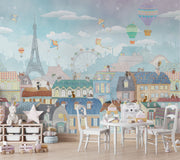 Paris-themed kids’ wall mural with the Eiffel Tower, hot air balloons, colorful rooftops, and kites in soft pastel colors, perfect for a nursery or playroom.