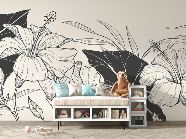 Children’s room with toys and a bench set against a monochrome botanical wallpaper with floral line illustrations.


