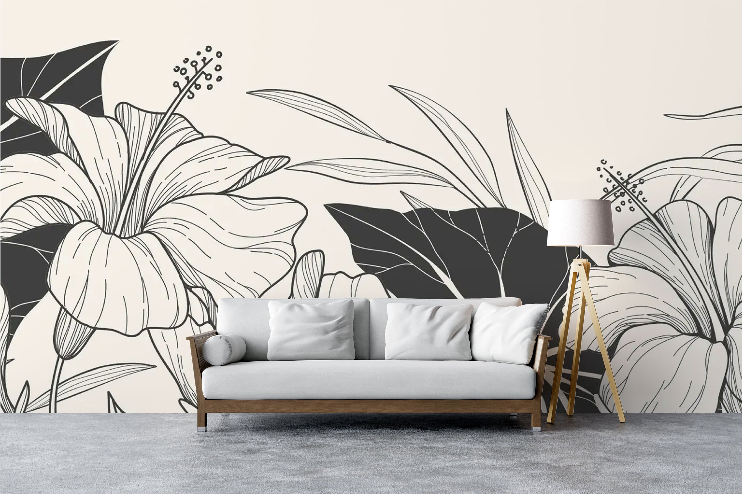 Modern living room with black and white floral wall mural featuring large line-art hibiscus flowers and bold leaves.