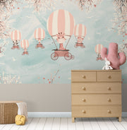 Whimsical kids’ wall mural with baby animals in hot air balloons, cherry blossoms, and a pastel sky—perfect for nurseries and playrooms.