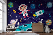 Navy Cartoon Astronaut and Rocket Wall Mural – nursery with a chest of drawers and armchair mock-up