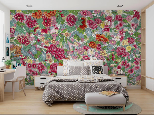 Bedroom with floral wallpaper, bed, and desk.