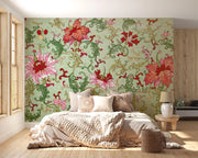 Vintage floral damask wall mural with large red and pink flowers and green vines decorating a bedroom.