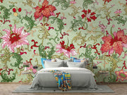 Bedroom with colorful floral wallpaper and a bed with gray bedding and multicolored blanket.