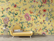 Yellow floral-patterned wallpaper with a yellow sofa and decorative table.