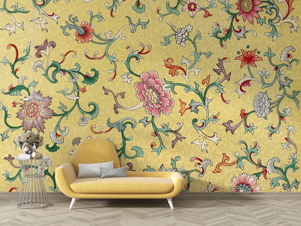 Yellow floral-patterned wallpaper with a yellow sofa and decorative table.