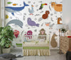 Children's room with crib, colorful animal wallpaper, and wooden dresser.