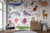 Children's room with colorful animal-themed wallpaper and furniture.