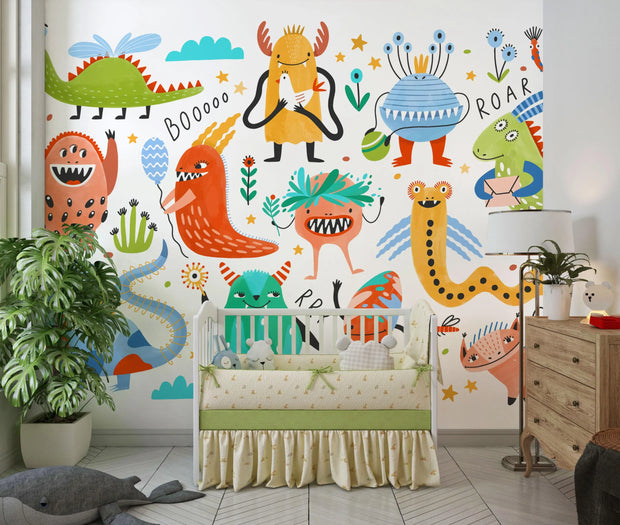 Children's room with colorful monster-themed wall mural and crib.