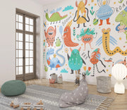 Children's room with colorful monster wall mural on a white wall.