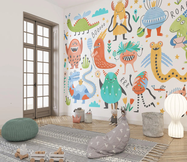 Children's room with colorful monster wall mural on a white wall.